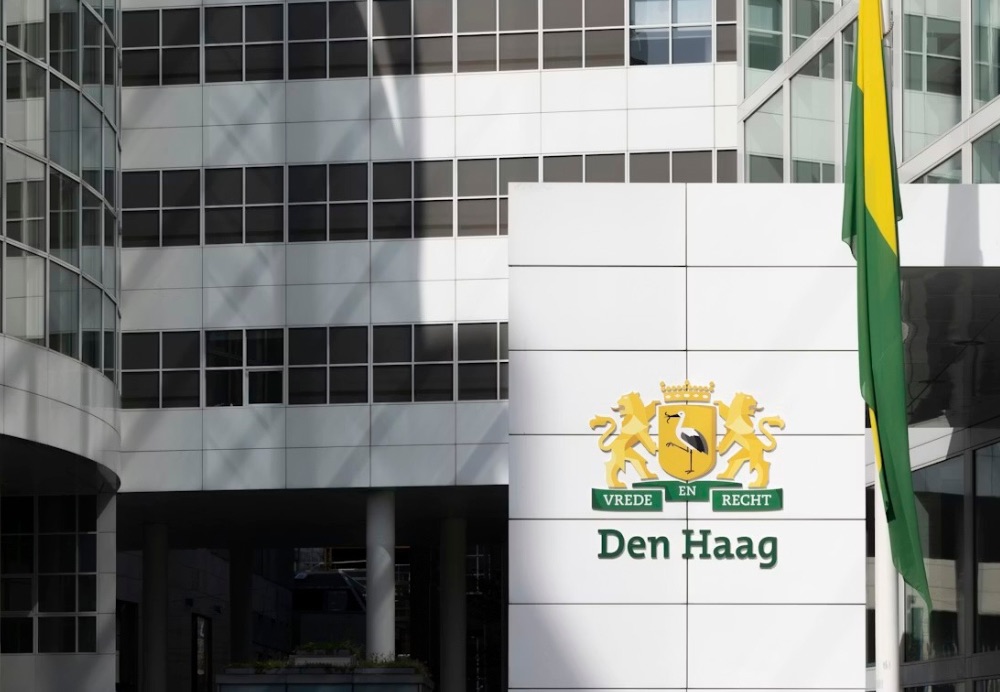 The Hague City Hall with a flag flying outside of it.